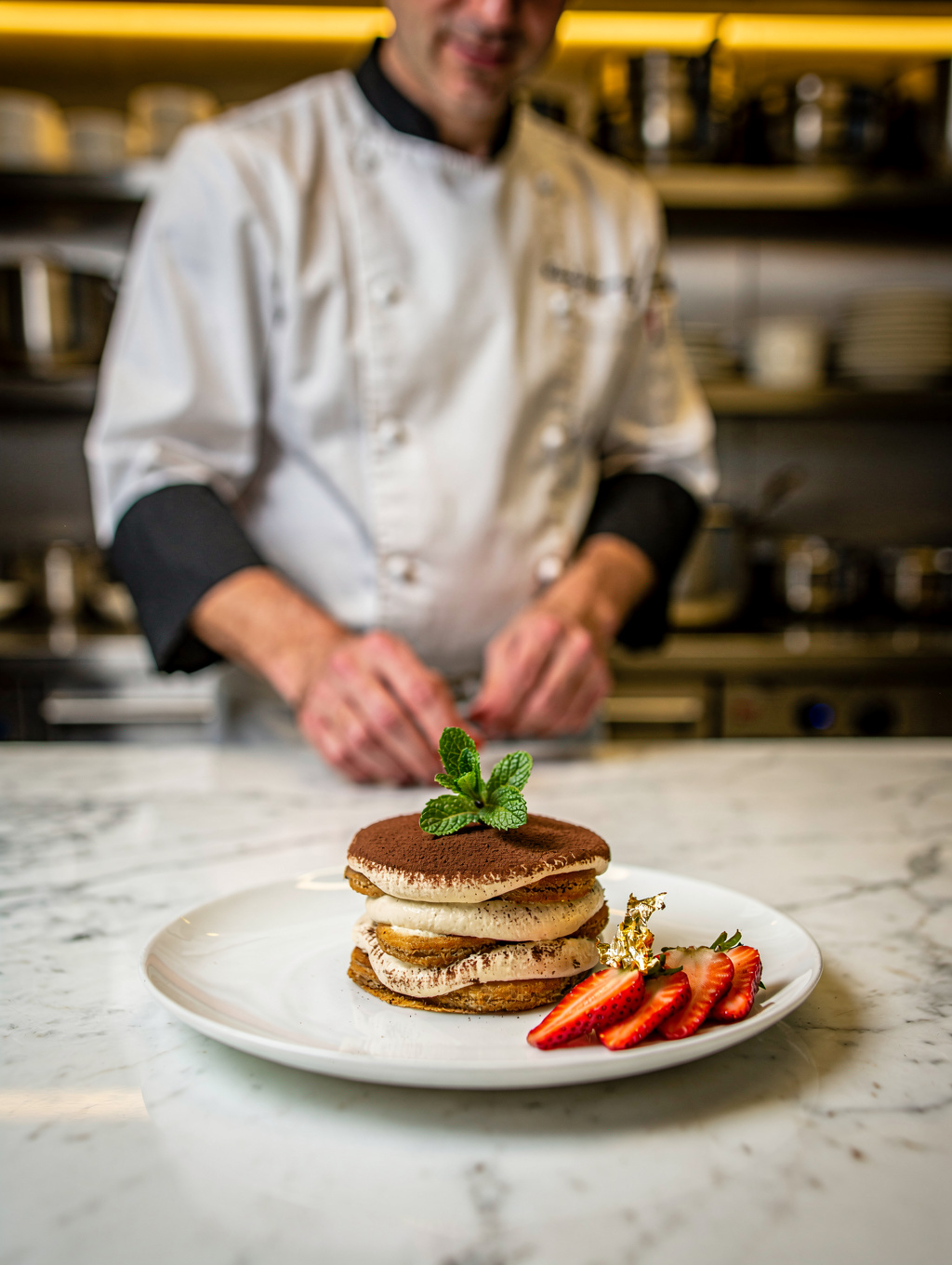 Chef Matteo Conti plating a signature Italian dessert